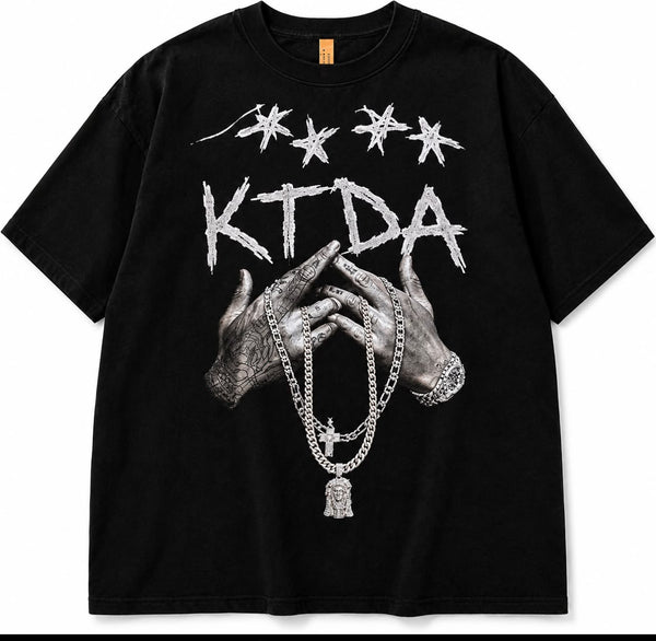 Black KTDA Signature graphic T-shirt with distressed lettering, illustrated hands and monochrome chain artwork.